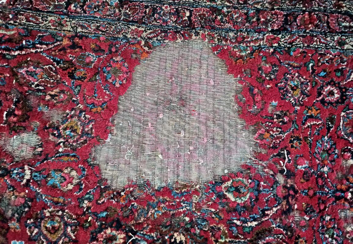 A moth-eaten handmade rug